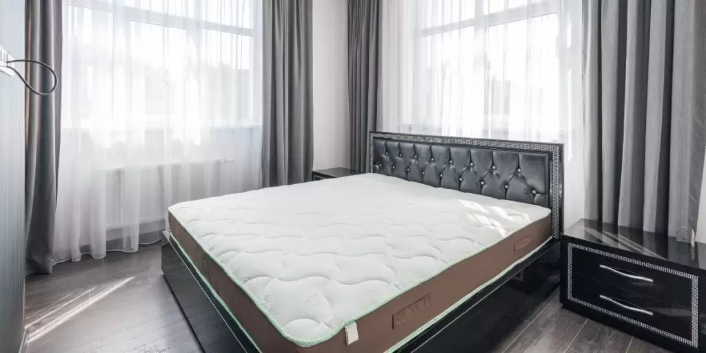 a mattress on a bed in a hotel room