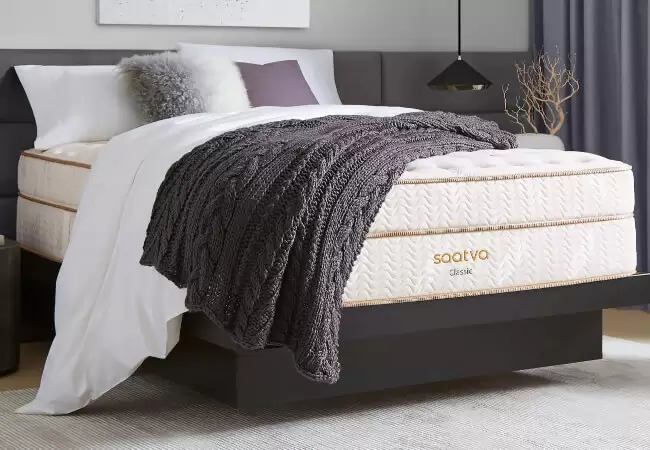 The Saatva Classic mattress on a bed